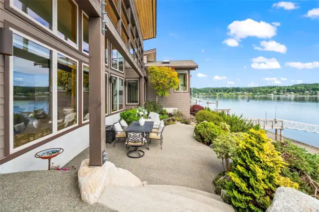 This inviting patio overlooks the bay, with steps leading through mature gardens to the waterfront—peaceful, private, and picture-perfect.