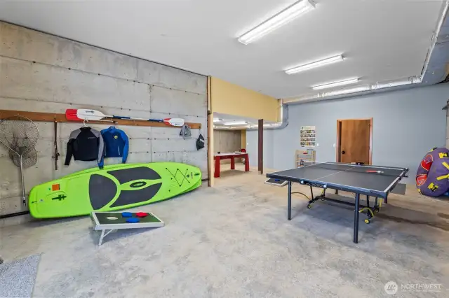he daylight basement is the ultimate hangout zone—set up for fun with ping pong, cornhole, and space to unwind.