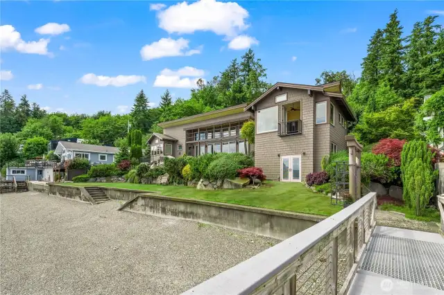 Step outside and discover mature, impeccably curated landscaping that leads to a private beach just steps away and a shared dock perfect for boating, fishing, swimming, and kayaking adventures. Wildlife abounds, creating a serene backdrop that connects you to nature's rhythm.