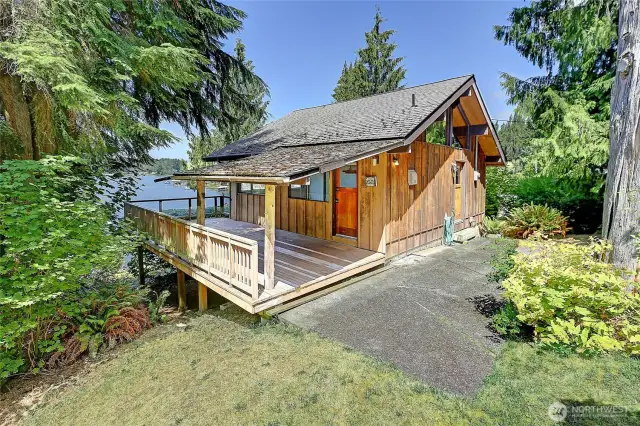 Rustic waterfront cabin with spacious, covered deck overlooking onto the sought after Lake Goodwin.