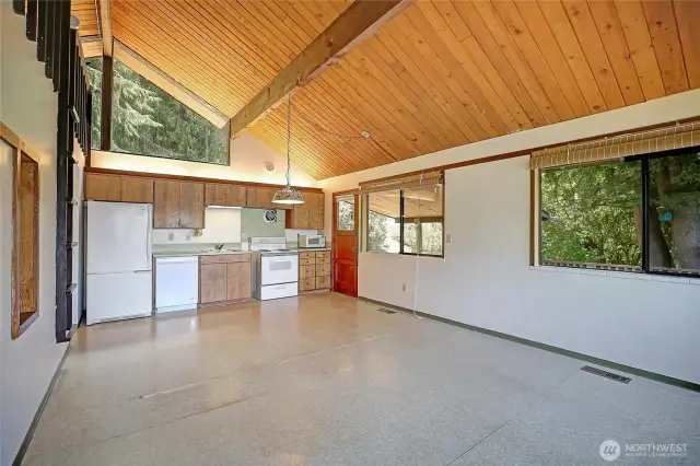 Open concept living space with large windows surrounding, creating so much natural light.