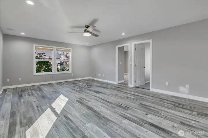 Upper-level bonus room with laminate vinyl plank flooring that offers durability and style.