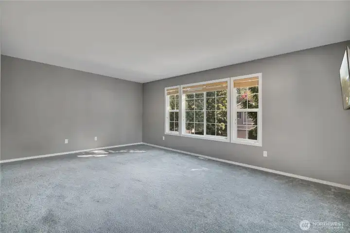 Spacious primary bedroom filled with natural light.