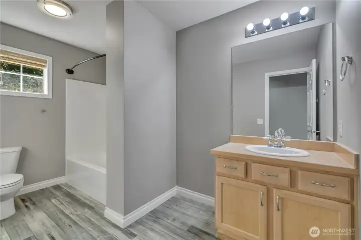 Full bath with tub/shower combo.