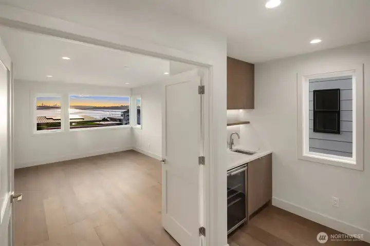 2nd floor wet bar looking into primary suite with a view!