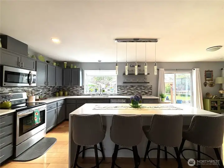 beautifully updated kitchen, stainless appliances, waterfall island, hardwood flooring...