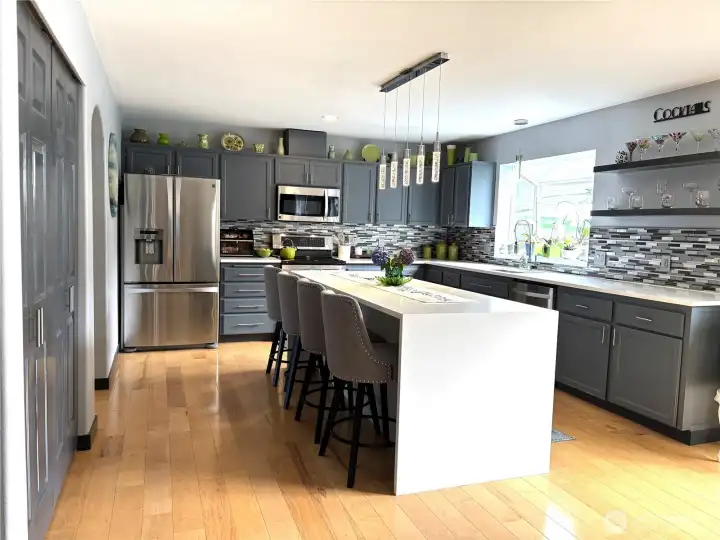 beautiful kitchen with waterfall sitting island