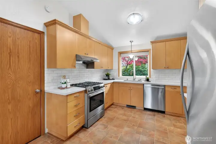 Newly updated kitchen (2025) with plenty of storage. Quartz countertops, tile backsplash and stainless steel appliances