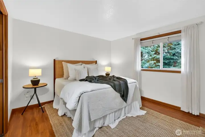 Primary bedroom w/ full bathroom (neighbors can't see in these windows. Lives extremely private in the best way possible.)