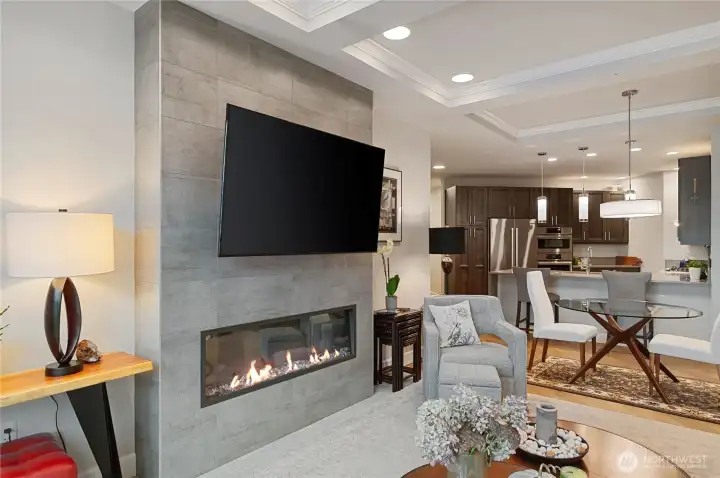 Open great-room living with a modern, sleek electric fireplace for cozy evenings, and seamless flow into the designer kitchen.