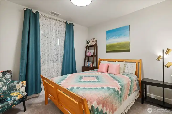 Comfortable guest bedroom featuring soft natural tones and ample space for a full furniture set