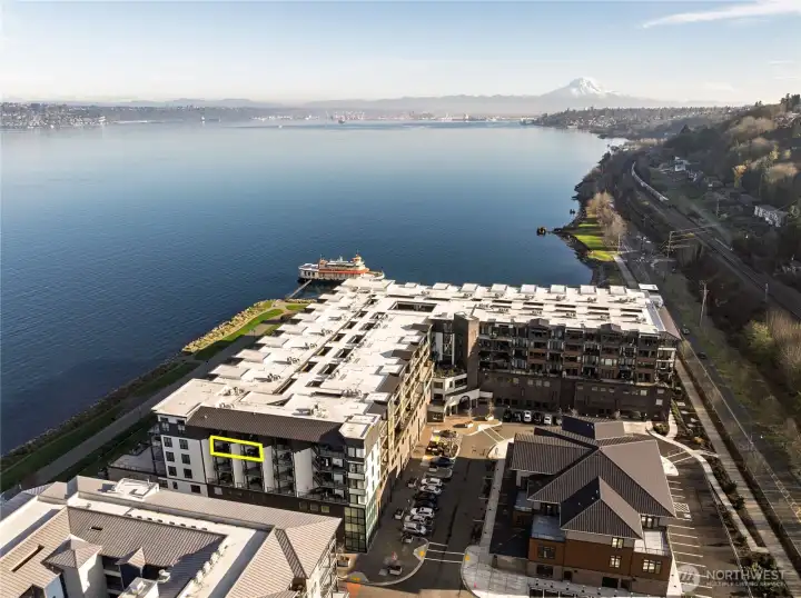 Steps from the waterfront trail, this luxury condo (outlined in yellow) offers direct access to scenic walking paths, the public dock, and expansive green spaces. Prime location for sunset strolls and year-round Puget Sound enjoyment.