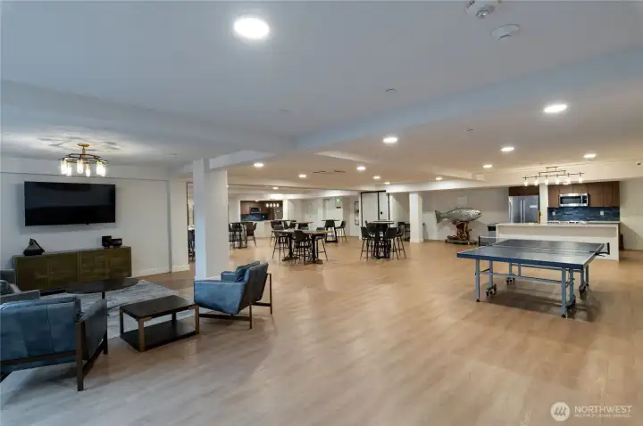 Media & Lounge Area  Kick back in the media lounge with a wall-mounted TV, modern furnishings, and direct access to the event-ready communal kitchen and game zone.