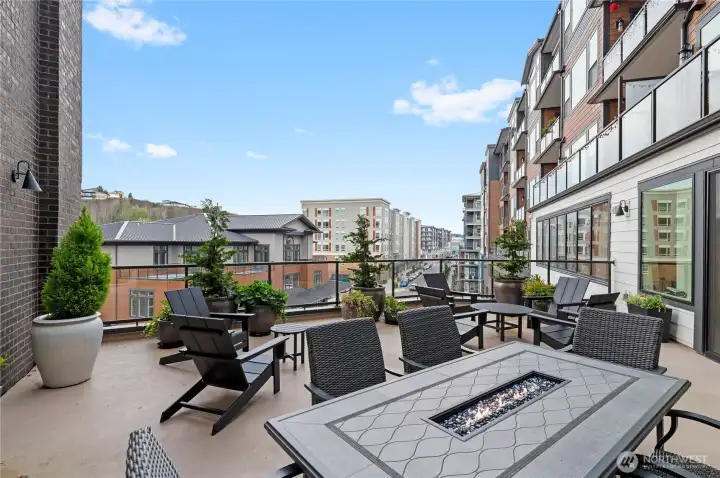 Outdoor Terrace with Fire Table  Enjoy fresh air and city views from the spacious shared terrace—complete with cozy seating and a built-in fire table for year-round ambiance.