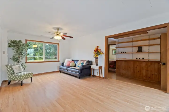 Living room with built-in shelves in the hallway in the distance ...