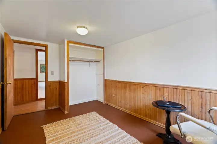 Another view of the additional bedroom with beautiful wood paneling ...