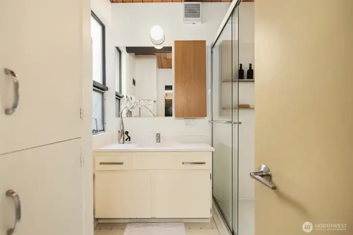 Cheery and bright 3/4 bath outside the two upper bedrooms.