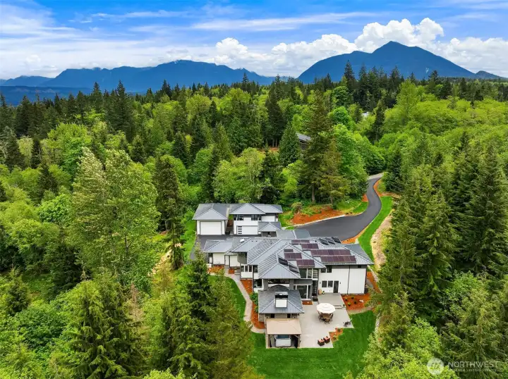 Perched on a beautifully landscaped 3-acre lot with stunning mountain views, this architectural gem features clean lines, expansive windows, and a warm, inviting interior filled with natural light.