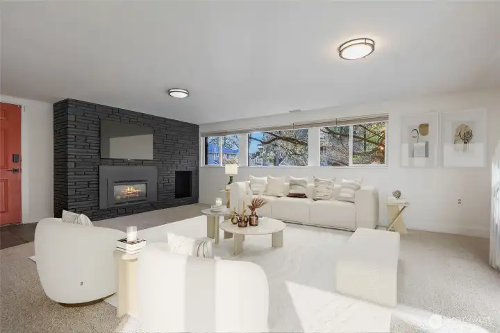 Downstairs family room with gas fireplace virtually staged