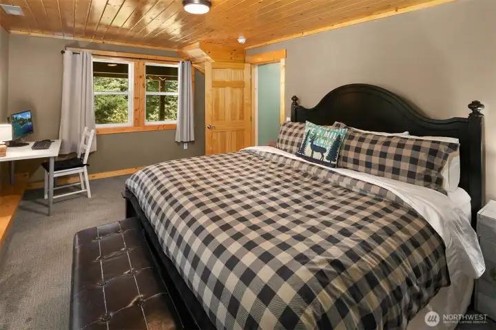 Primary bedroom boasts gorgeous knotty pine ceilings