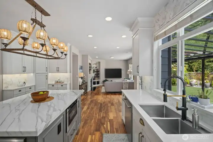 So much space for entertaining. Open floor plan featuring Living Room, Dining Room, eat-in kitchen and Family Room with gas fireplace and built in shelving.