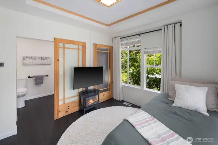 Main floor bedroom with heated flooring and full bath