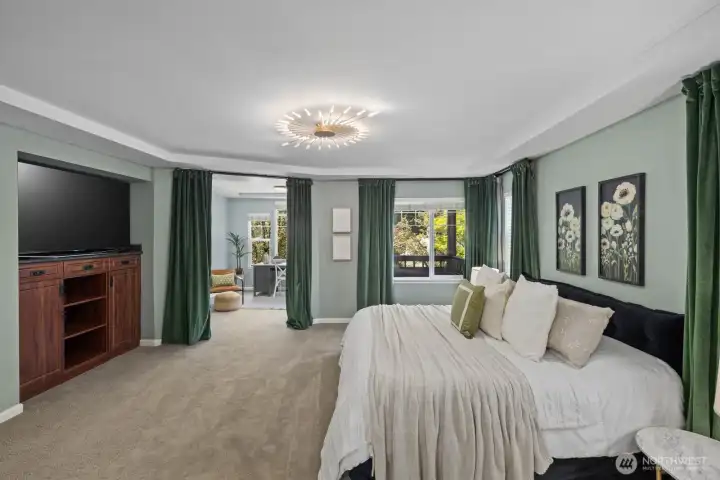 Primary Bedroom with built-in TV console and TV. Sitting area/flex room and deck access.