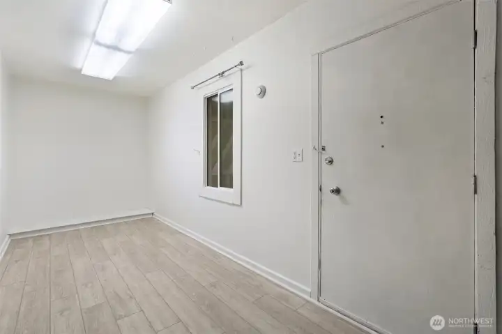Mudroom off of driveway, utility area
