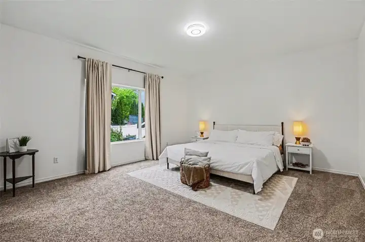 Generously sized primary bedroom could fit sitting space or office desk.