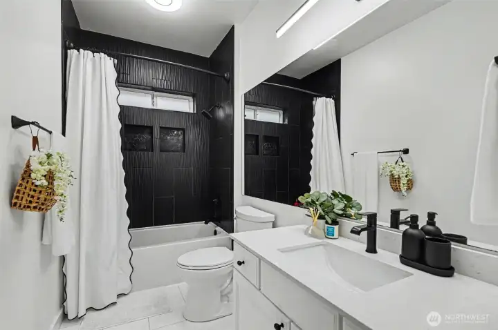 Updated Bathroom with new quartz counters and refinished cabinets.