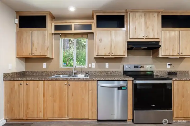 Nice wood cabinets offer plenty of storage and add warmth to the kitchen