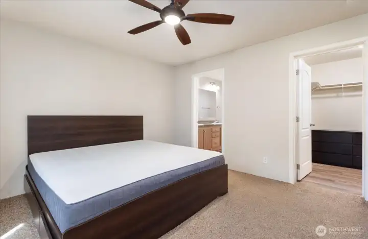 Primary Bedroom with a full bath also includes a walk-in closet. This is a king-size bed