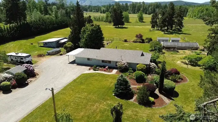 Usable acreage with multiple outbuildings and open space.