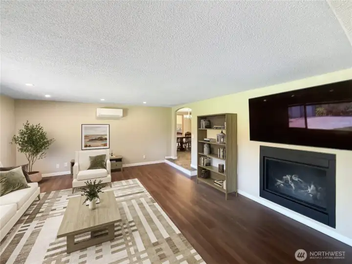 Cozy propane fireplace creates warm and inviting gathering space.  virtually staged