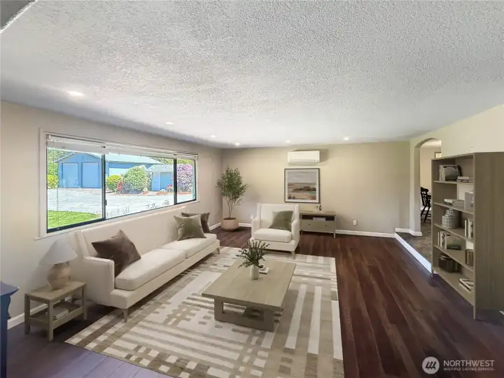 See that ductless unit? Keep you cool with AC in the summer and energy efficient heating year round. Updated living room with reengineered hardwood flooring and natural light.  vitual staging