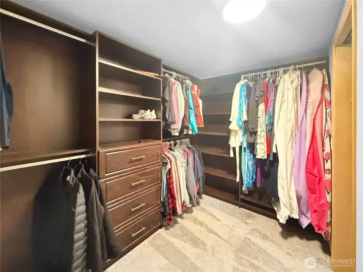 Walk-in closet with custom cabinets included.