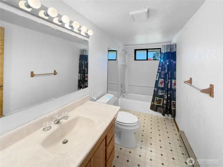 Functional guest bathroom located near the additional bedrooms, offering convenient shared access for guests, family, or multi-use living arrangements.