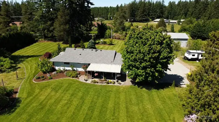 Spacious usable acreage with a mix of pasture, garden space, and structures