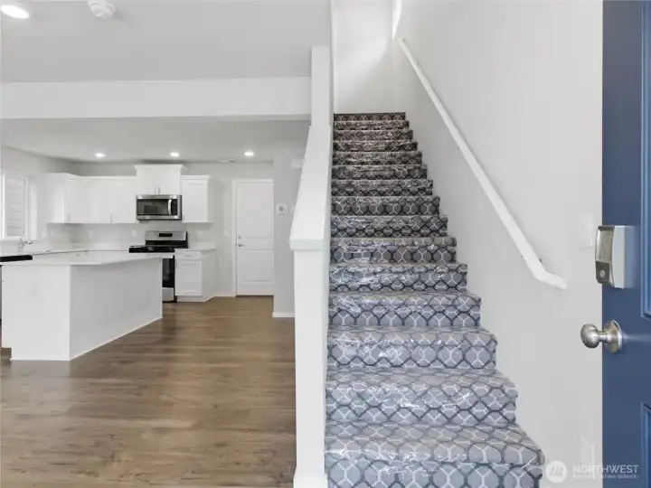 As you enter the home, you will find your open-concept living space to your left, and stairs leading up to your right. As you enter the home, you will find your open-concept living space to your left, and stairs leading up to your right.