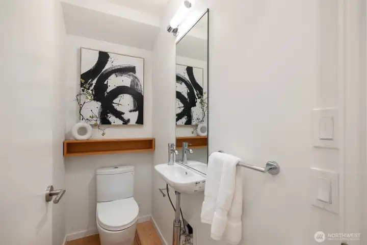 The main floor powder room adds both style and convenience, providing a tasteful and accessible amenity. The main floor powder room adds both style and convenience, providing a tasteful and accessible amenity.