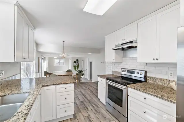 The kitchen flows to the breakfast nook and family room.