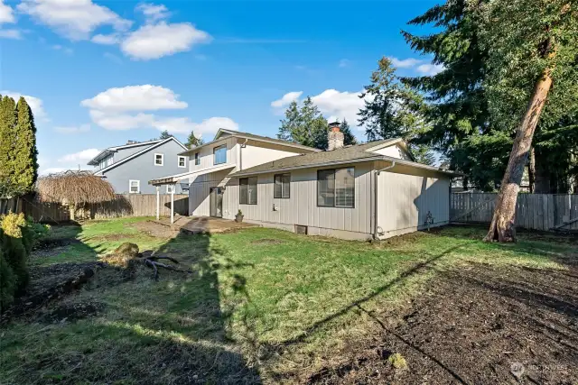 Another view of the covered deck and fully fenced back yard.