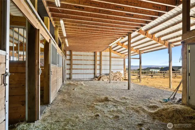 Inside the 4-stall barn there is an open area to tack up or store hay.  The lights make it easy to use year round!