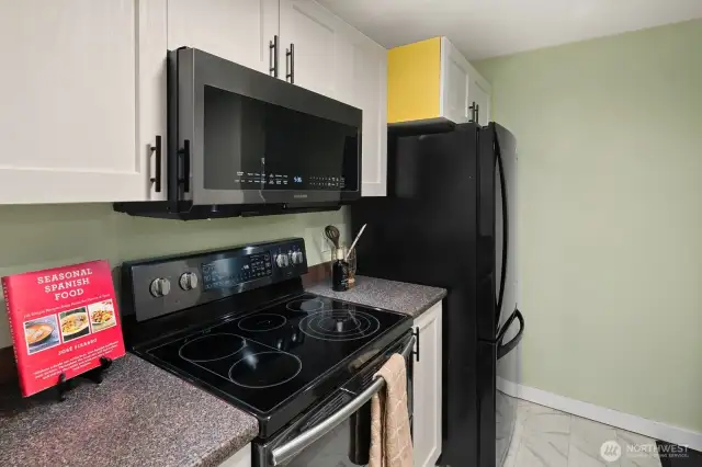 Open living/dining/kitchen w/ slider opening to patio & yard space