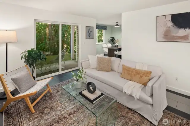 Open living/dining/kitchen w/ slider opening to patio & yard space