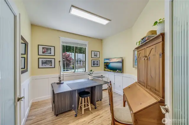 Off the entry is the office with beautiful wainscoting and glass French doors with a privacy film.