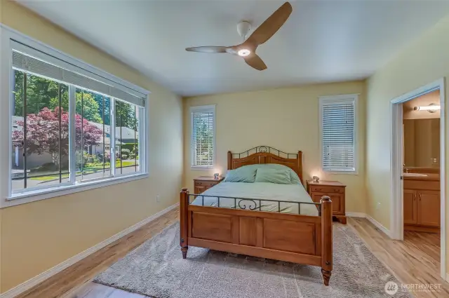 Spacious primary bedroom with a 3/4 en-suite bath.