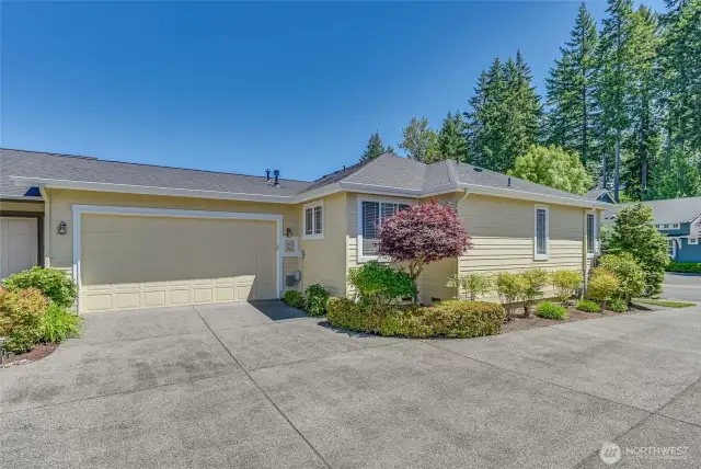 The two car garage has storage space and an overhead hanging storage area.