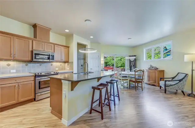 The cabinets have soft closing hinges and the lower ones have handy pull-out shelves. The island counter provides counter seating and the back counters are accented by a custom backsplash
