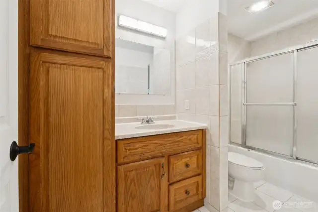 Bath with tile floor and walls